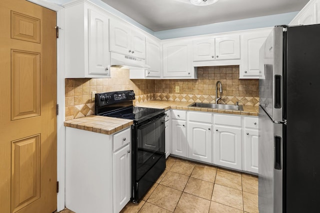 7914 Dutch Ct, North Charleston, SC 29420 - kitchen with stainless steel fridge, electric range, a sink, under cabinet range hood, and tile countertops