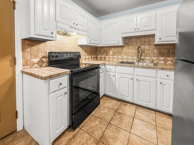 7914 Dutch Ct, North Charleston, SC 29420 - kitchen featuring electric range, freestanding refrigerator, a sink, under cabinet range hood, and tile countertops