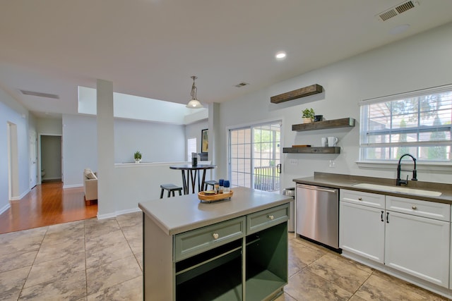 9682 Pebble Creek Blvd, Summerville, SC 29485 - kitchen featuring stainless steel dishwasher, a sink, open shelves, a kitchen island, and white cabinetry
