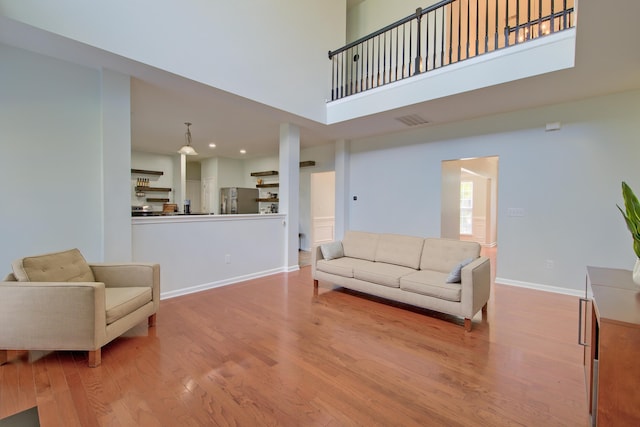 9682 Pebble Creek Blvd, Summerville, SC 29485 - living room featuring wood finished floors, a high ceiling, baseboards, and recessed lighting