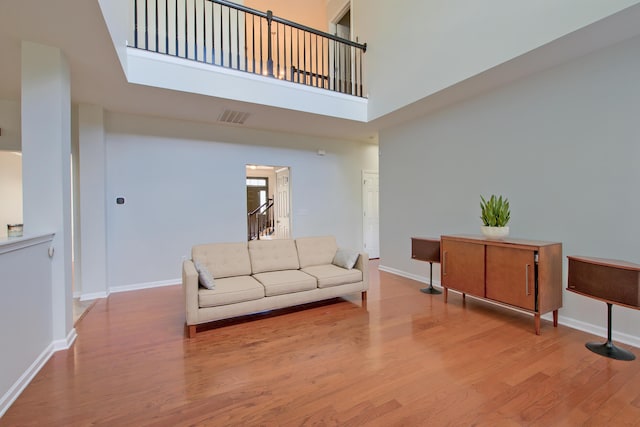 9682 Pebble Creek Blvd, Summerville, SC 29485 - living area featuring wood finished floors, baseboards, a towering ceiling, and stairs