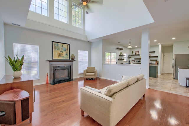 9682 Pebble Creek Blvd, Summerville, SC 29485 - living area with ceiling fan, a tile fireplace, light wood-style flooring, baseboards, and recessed lighting