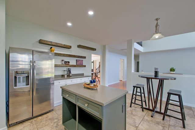 9682 Pebble Creek Blvd, Summerville, SC 29485 - kitchen featuring stainless steel refrigerator with ice dispenser, open shelves, a center island, white cabinetry, and decorative light fixtures