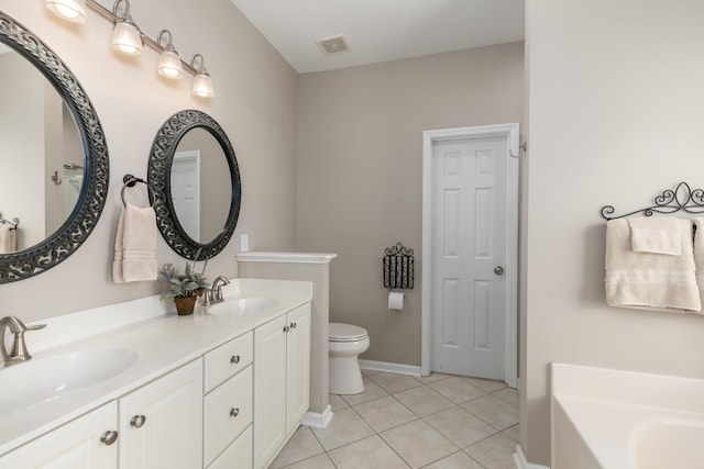 full bath with tile patterned flooring, a sink, a garden tub, and toilet