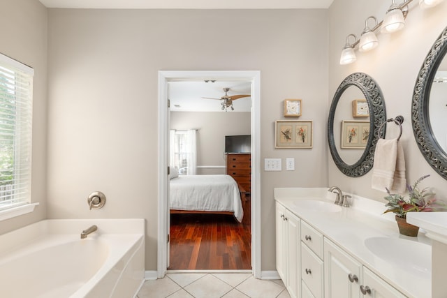 bathroom featuring a sink, tile patterned flooring, ensuite bath, a ceiling fan, and a bath