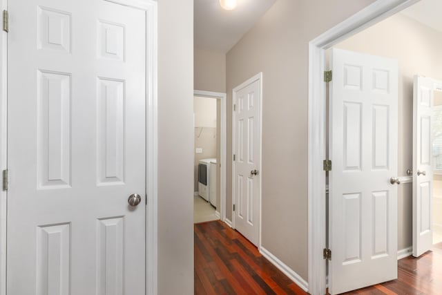 hallway featuring baseboards and dark wood-style floors
