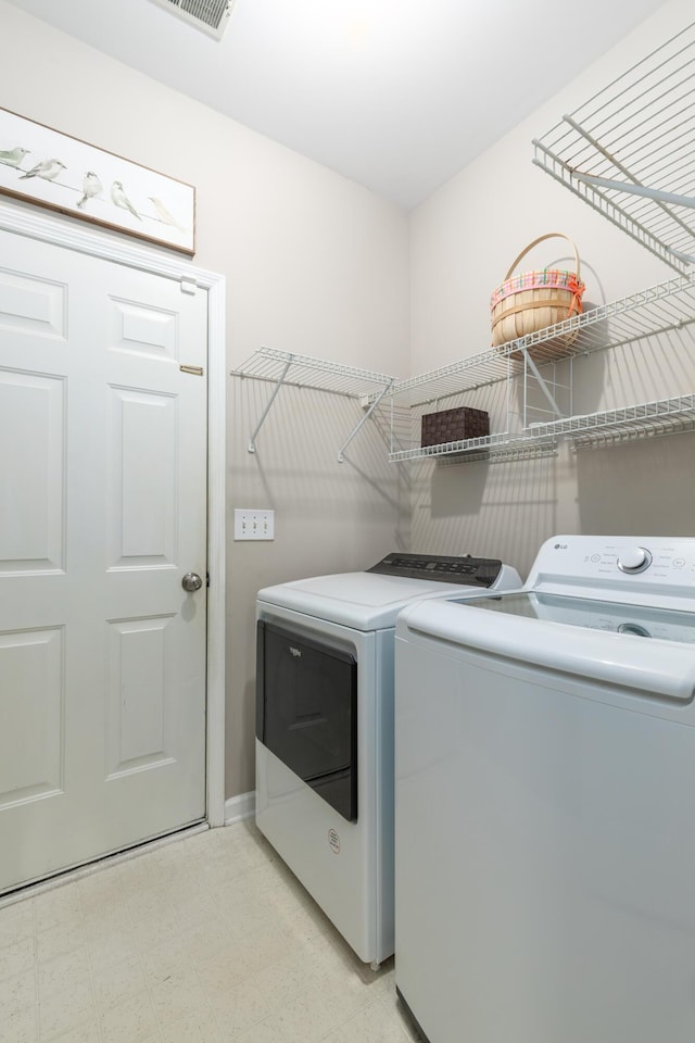 laundry area featuring light floors, laundry area, and independent washer and dryer