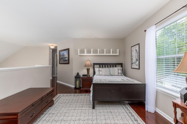 bedroom with baseboards and wood finished floors