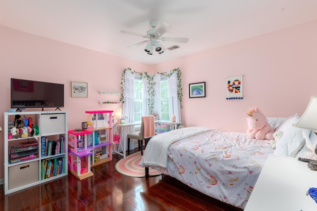 bedroom with visible vents, a ceiling fan, and wood finished floors