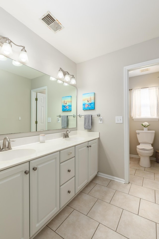 bathroom featuring a sink, tile patterned floors, and visible vents