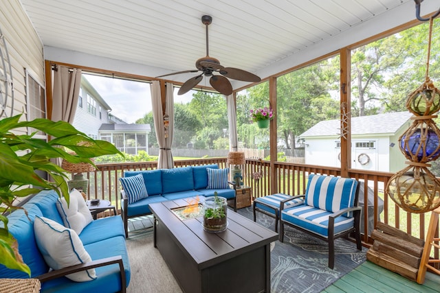 sunroom / solarium with an outdoor living space and a ceiling fan