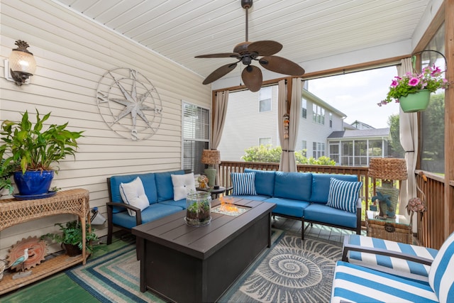 exterior space with a sunroom, a ceiling fan, and an outdoor living space