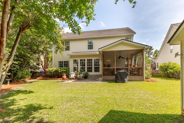back of house featuring a fenced backyard, a yard, ceiling fan, and a sunroom