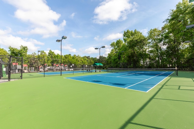 view of sport court featuring fence