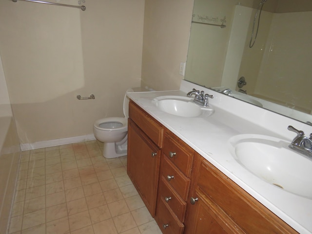 full bathroom featuring toilet, double vanity, bathtub / shower combination, and baseboards