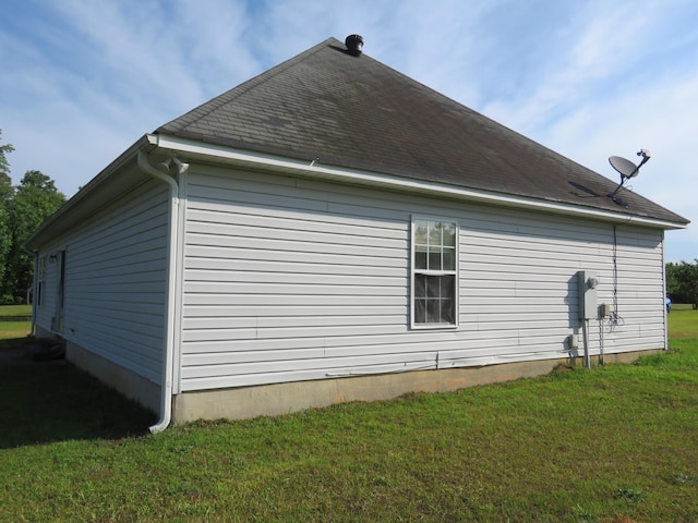 view of side of home with a yard