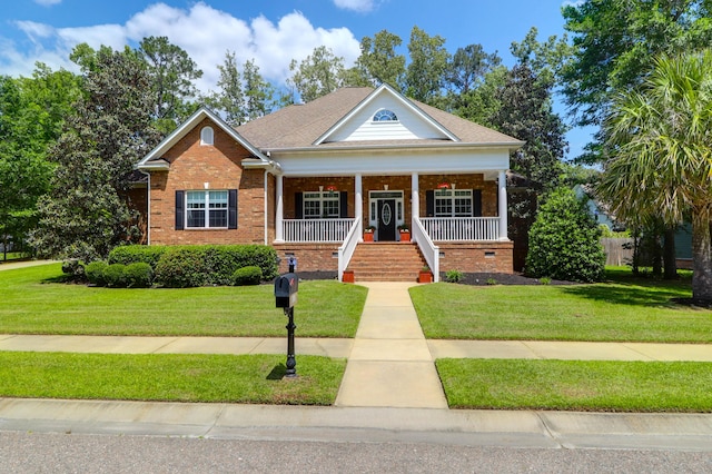 view of front facade featuring covered porch, brick siding, and a front lawn