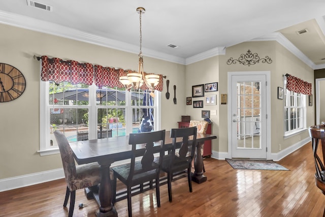 dining space featuring a notable chandelier, hardwood / wood-style flooring, and visible vents