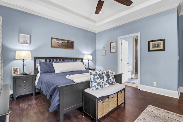 bedroom featuring crown molding, baseboards, a tray ceiling, and wood finished floors