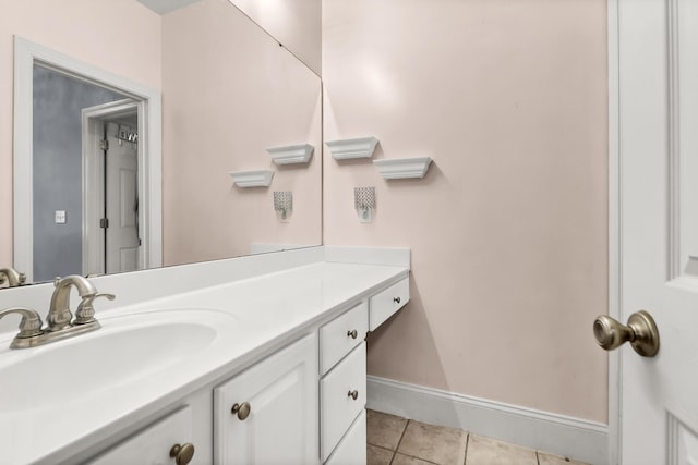 bathroom with tile patterned floors, baseboards, and vanity