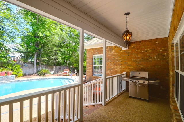 exterior space with a fenced backyard, a fenced in pool, and grilling area