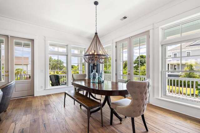 566 Wading Pl, Daniel Island, SC 29492 - dining room featuring a chandelier, healthy amount of natural light, and hardwood / wood-style flooring