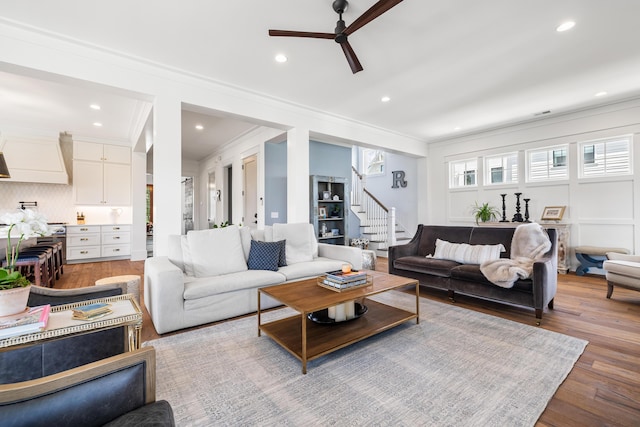 566 Wading Pl, Daniel Island, SC 29492 - living room with ceiling fan, ornamental molding, stairs, wood finished floors, and recessed lighting