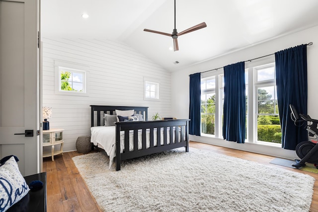 566 Wading Pl, Daniel Island, SC 29492 - bedroom with multiple windows, vaulted ceiling, wood finished floors, wood walls, and ceiling fan