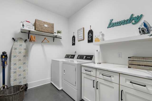 566 Wading Pl, Daniel Island, SC 29492 - washroom featuring washing machine and clothes dryer, cabinet space, and dark tile patterned floors
