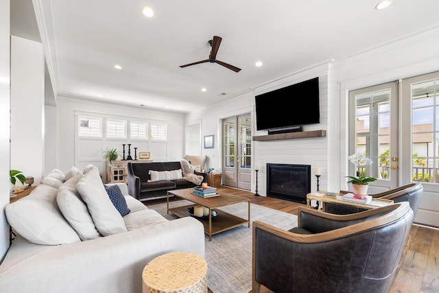 566 Wading Pl, Daniel Island, SC 29492 - living area featuring a ceiling fan, wood finished floors, ornamental molding, a large fireplace, and recessed lighting