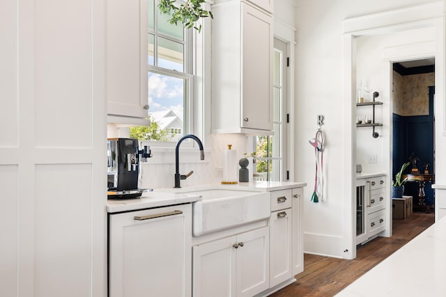 566 Wading Pl, Daniel Island, SC 29492 - kitchen with wood finished floors, white cabinetry, and light stone countertops