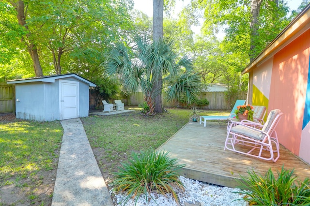 1159 Camden St, North Charleston, SC 29405 - view of yard featuring a storage shed, an outbuilding, a wooden deck, and a fenced backyard