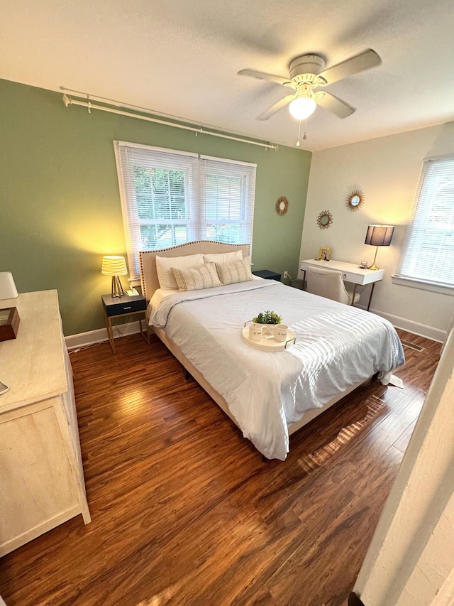 bedroom featuring baseboards, a ceiling fan, and wood finished floors