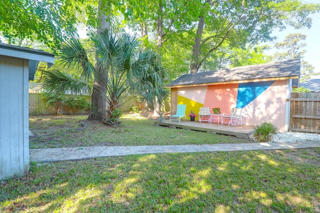 1159 Camden St, North Charleston, SC 29405 - view of yard with an outdoor structure, a wooden deck, and a fenced backyard