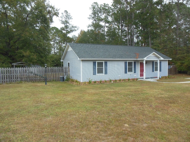 view of front of home with a front lawn and central AC unit