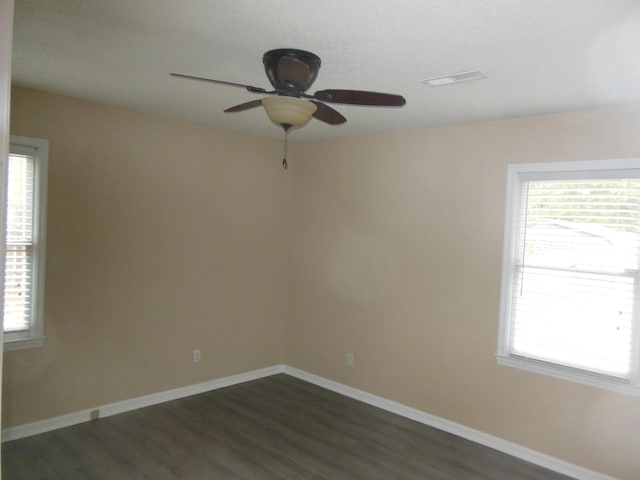 empty room featuring dark hardwood / wood-style floors and ceiling fan