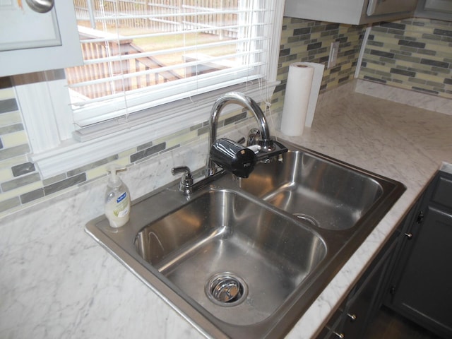 details featuring sink and backsplash