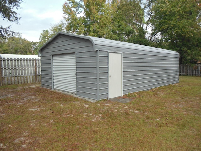 view of outbuilding featuring a lawn