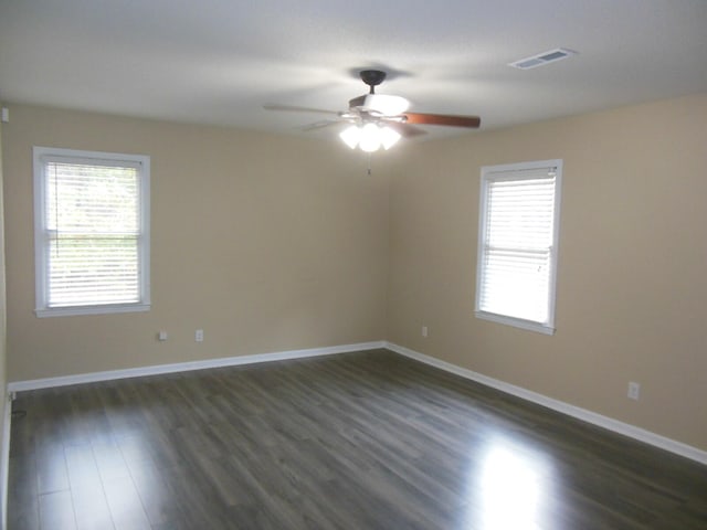 spare room with dark wood-type flooring and ceiling fan