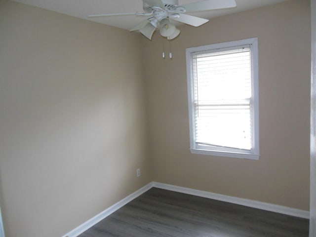 spare room with dark wood-type flooring and ceiling fan