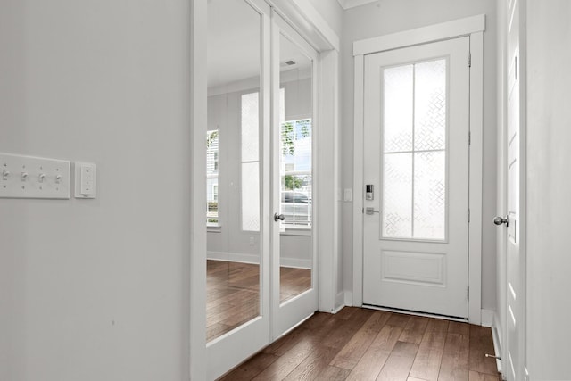 entryway with wood-type flooring and baseboards