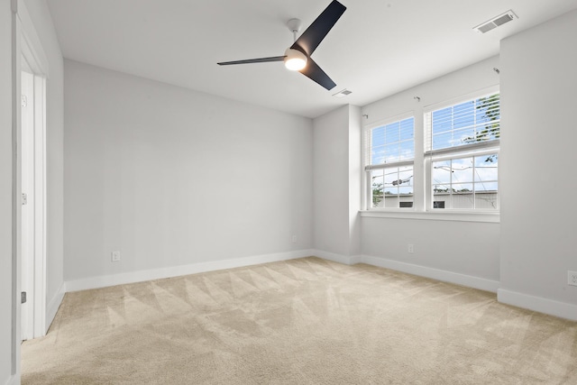 empty room with carpet, baseboards, and a ceiling fan