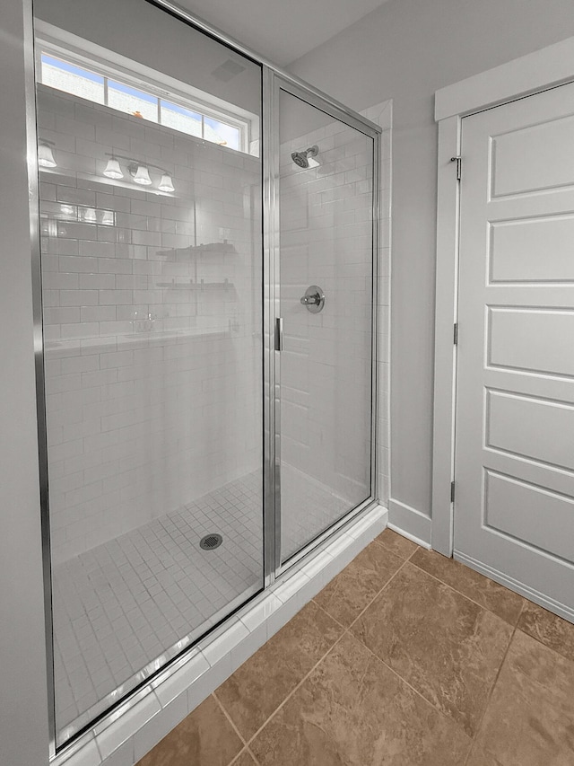 full bath with a stall shower and tile patterned flooring