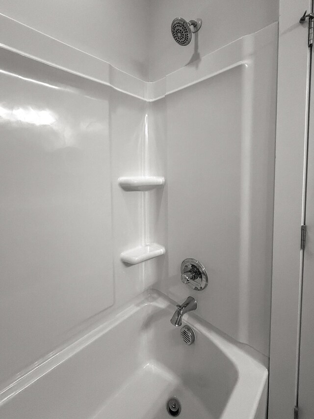 bathroom with bathing tub / shower combination