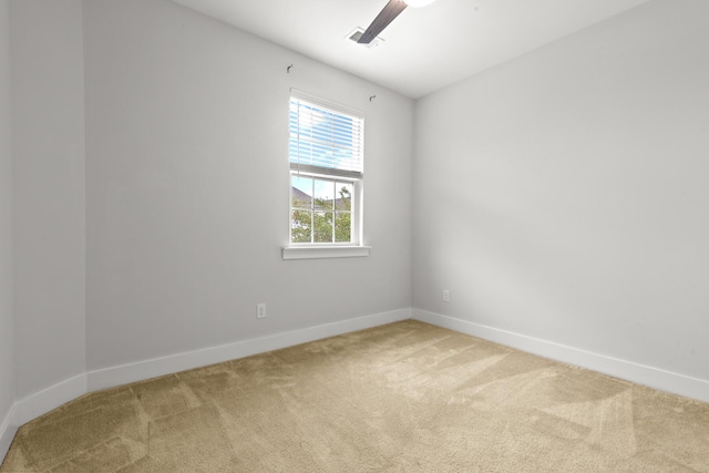 unfurnished room featuring light carpet and baseboards