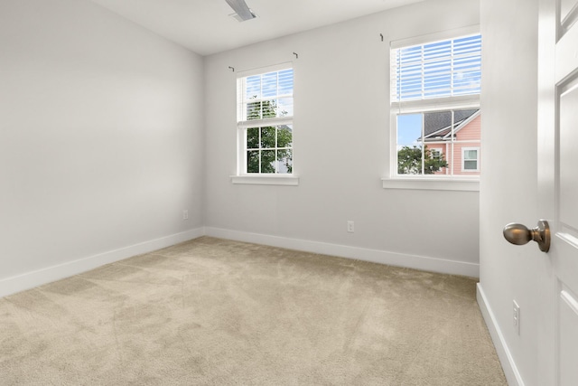 carpeted spare room with baseboards