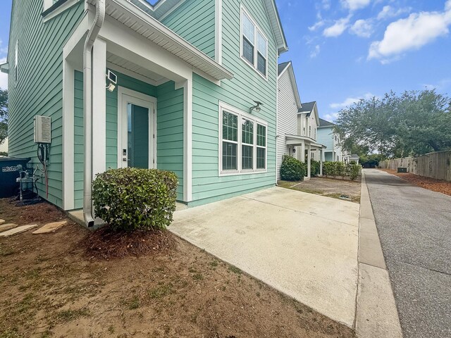 view of side of home featuring fence