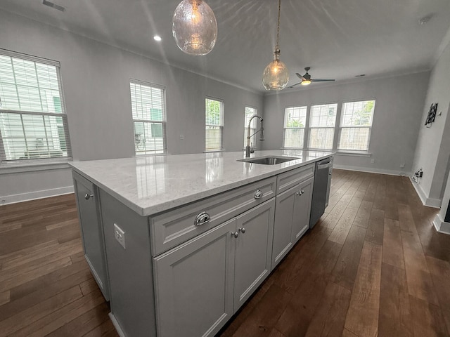 kitchen with a sink, stainless steel dishwasher, dark wood-style floors, baseboards, and recessed lighting