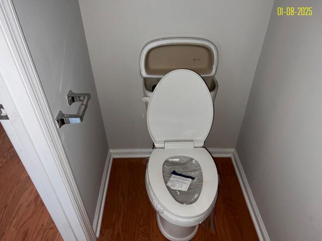 bathroom with wood-type flooring and toilet