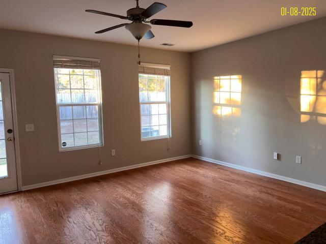 unfurnished room with ceiling fan and hardwood / wood-style floors